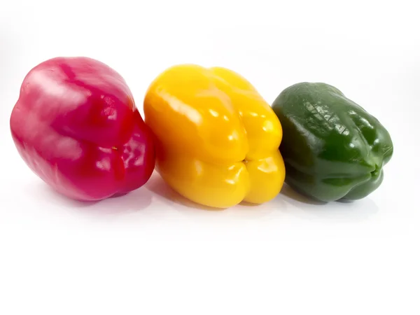 stock image Three peppers of different colors with a white background