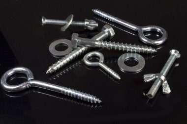 Screws, nuts and hardware store on a black background clipart