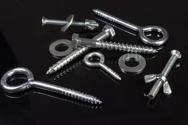 Screws, nuts and hardware store on a black background — Stock Photo, Image