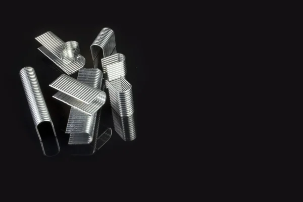 Professional pile of staples on a black background — Stock Photo, Image
