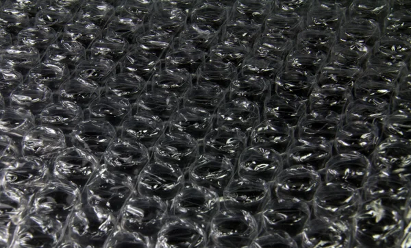 Plast bubbla på svart bakgrund — Stockfoto