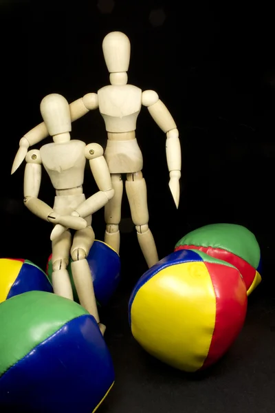 Humanoid couple hugging with juggling balls in bright colors — Stock Photo, Image