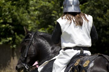 Medieval knight on his horse galloping clipart