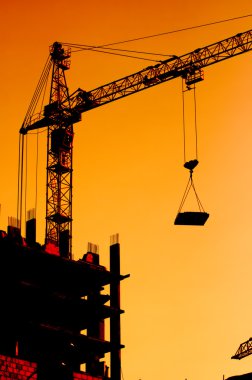 Construction crane at sunset clipart