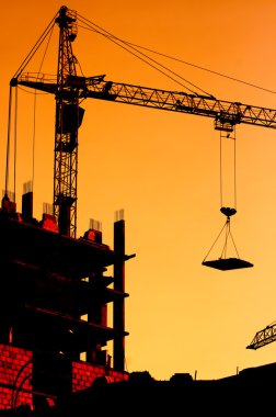 Construction crane at sunset clipart