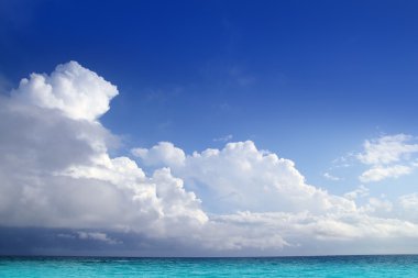 Caribbean aqua sea clouds in blue sky horizon clipart
