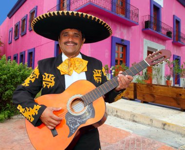 Charro Mariachi playing guitar Mexico houses clipart