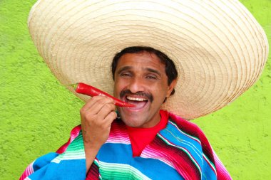 Mexican man poncho sombrero eating red hot chili clipart