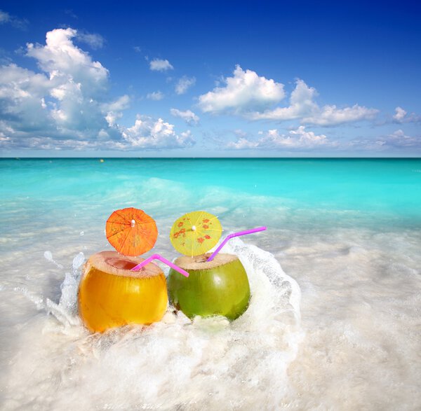 Coconut cocktails juice in tropical beach water splash