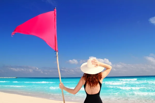 Beach rear woman holding red beach flag pole — Stock Photo, Image