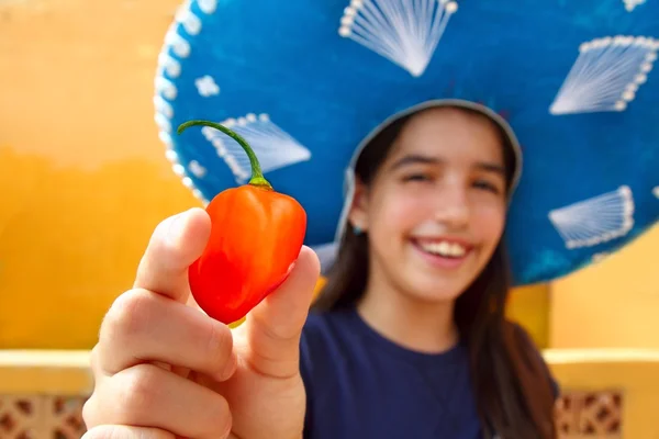 Mexican girl habanero orange hot chili pepper — Stock Photo, Image