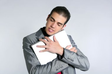 Businessman young embracing computer, hug laptop clipart