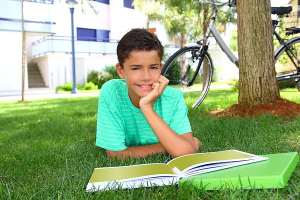 Boy teen studying laying green grass garden — Stock Photo, Image