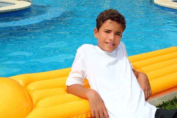Menino adolescente férias descansar na piscina flutuar — Fotografia de Stock