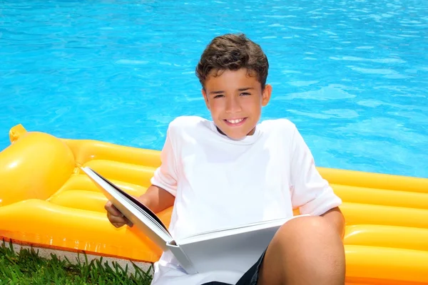 Boy student teen vacation homework pool float — Stock Photo, Image