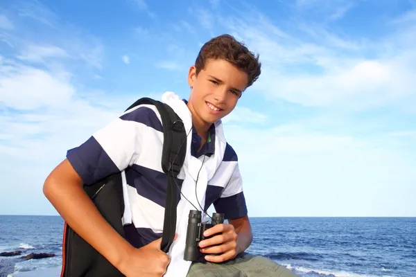 Boy teenager binoculars explorer in blue beach — Stock Photo, Image