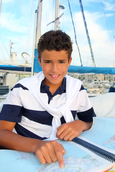 Boy teen sailorsitting on marina boat chart map — Stock Photo, Image