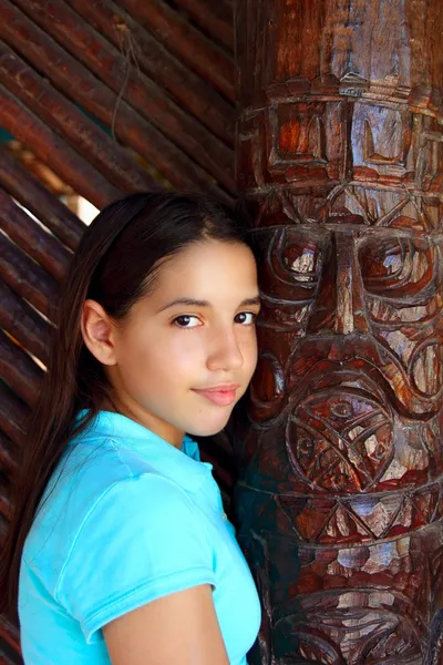 Latin mexican teen girl smile indian wood totem — Stock Photo, Image