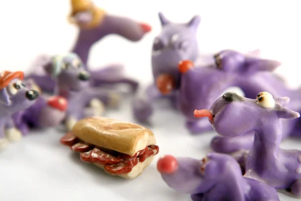 Handmade hungry plasticine dogs, meat to eat — Stock Photo, Image