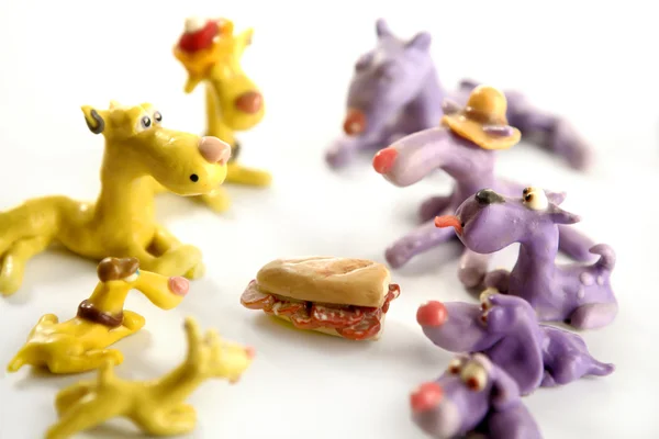 Handmade hungry plasticine dogs, meat to eat — Stock Photo, Image