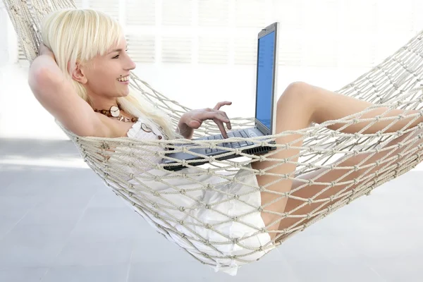 Blonde young student fashion girl laptop hammock — Stock Photo, Image