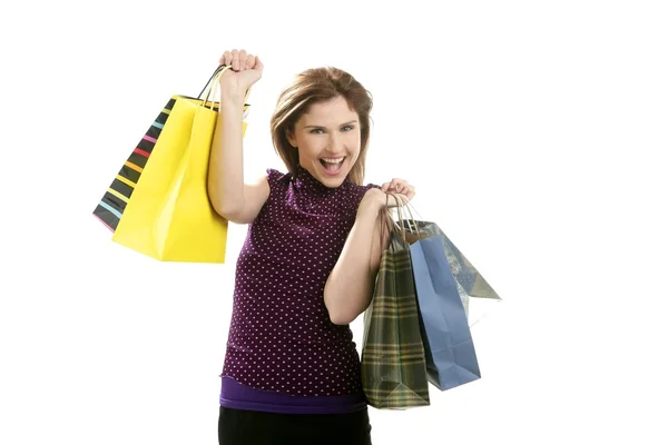 Mulher Shopaholic com sacos coloridos sobre branco — Fotografia de Stock