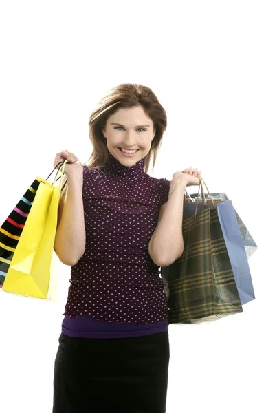 Shopaholic Frau mit bunten Taschen über Weiß — Stockfoto