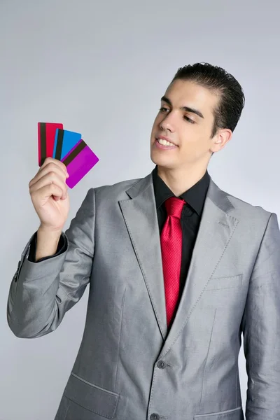 Empresario joven con tres tarjetas de crédito — Foto de Stock