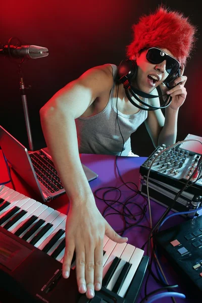 Dj with colorful light and music mixing equipment — Stock Photo, Image