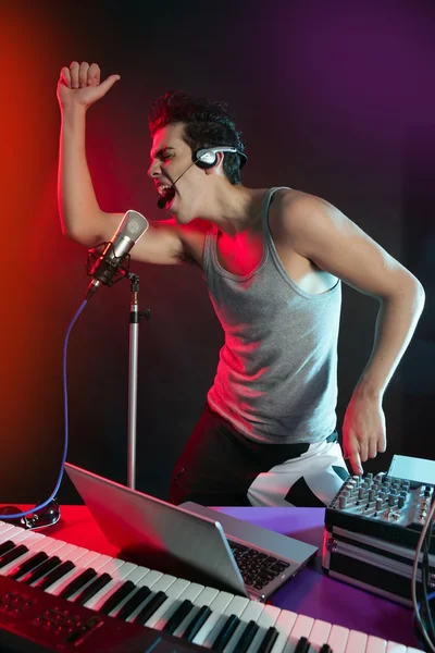 DJ met kleurrijke licht en muziek apparatuur mengen — Stockfoto