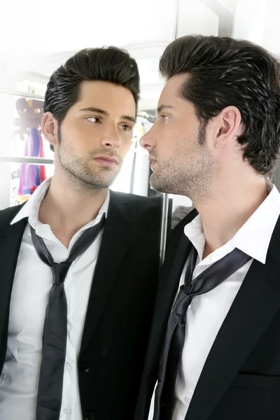 Handsome narcissistic young man looking in a mirror — Stock Photo, Image