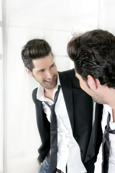 Handsome narcissistic young man looking in a mirror — Stock Photo, Image