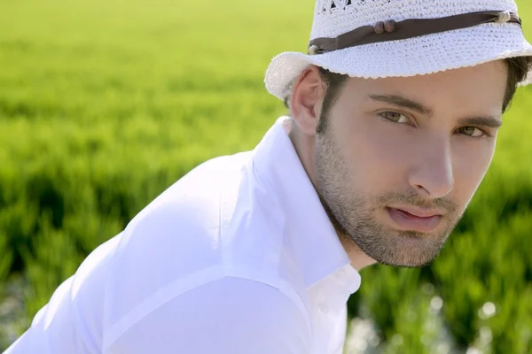 Mediterranean man portrait white hat inmeadow — Stock Photo, Image
