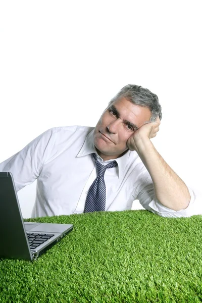 Businessman senior relaxed on green grass desk — Stock Photo, Image