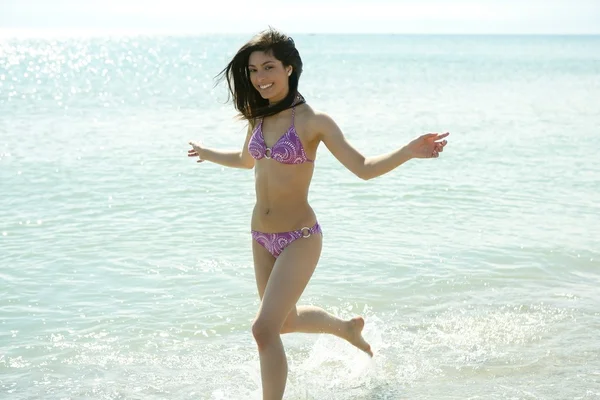 Sahilde bikinili çalışan güzel bir kadın — Stok fotoğraf