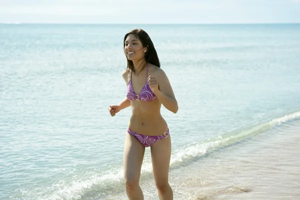 Красивая женщина бегает в бикини по пляжу — стоковое фото