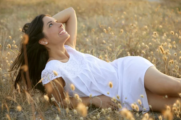 Beautiful indian brunette in a golden field — Stock Photo, Image