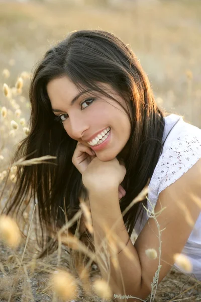 Beautiful indian brunette in a golden field — Stock Photo, Image