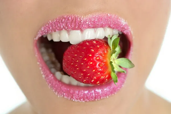 Delicious strawberry fruit in woman mouth — Stok fotoğraf