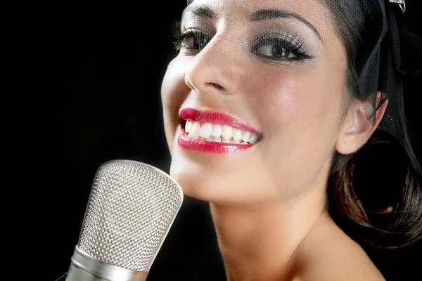 Beautiful woman singing on a vintage microphone — Stock Photo, Image