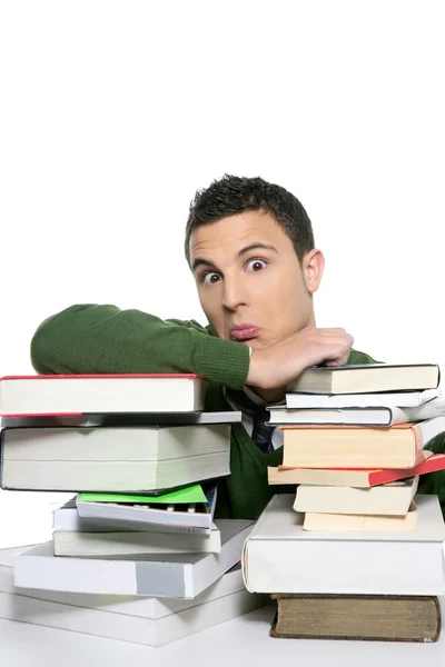Joven estudiante infeliz con libros apilados — Foto de Stock