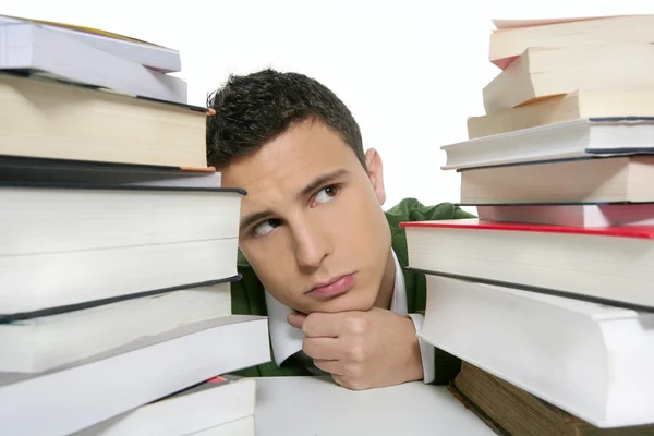 Young unhappy student with stacked books — Stock Photo, Image