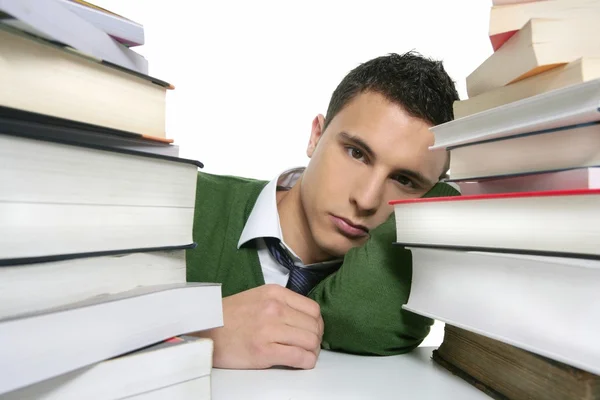 Jovem estudante infeliz com livros empilhados — Fotografia de Stock