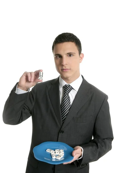 Businessman eating risk, domino metaphor — Stock Photo, Image