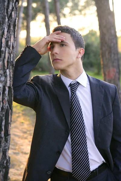 Businessman posing relaxed on a park forest — Stock Photo, Image