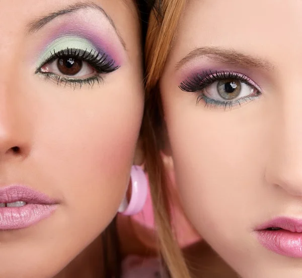 Maquiagem closeupl macro dois rostos multirracial em rosa — Fotografia de Stock