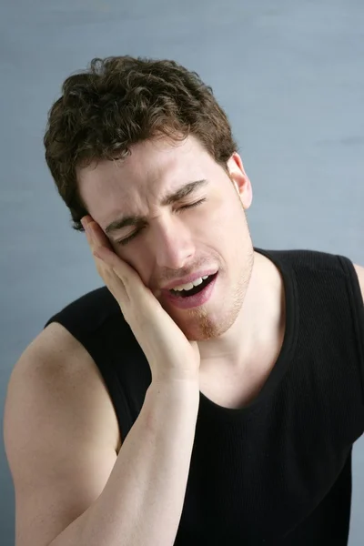 Toothache headache pain gesture young man — Stock Photo, Image