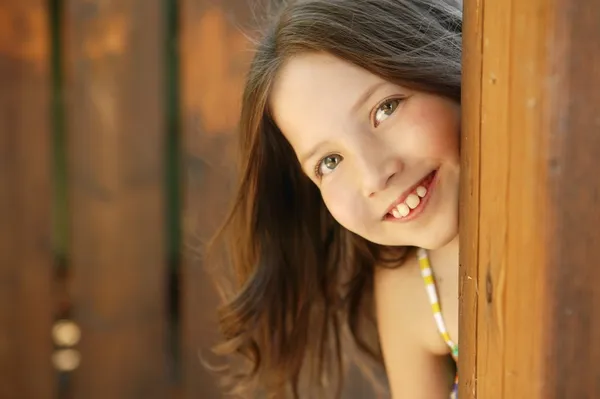 木製のドアの後ろに美しい少女 — ストック写真