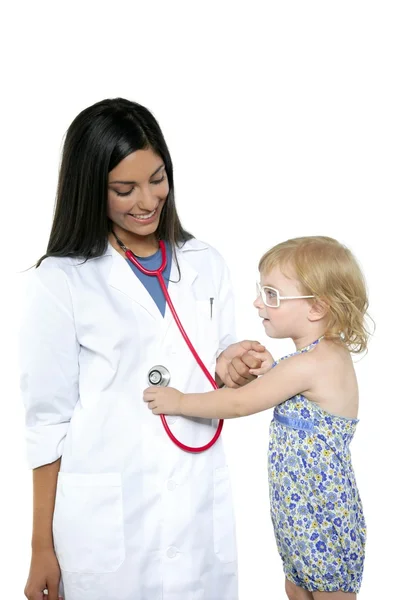 Brunette pediatric doctor with blond little girl Stock Image