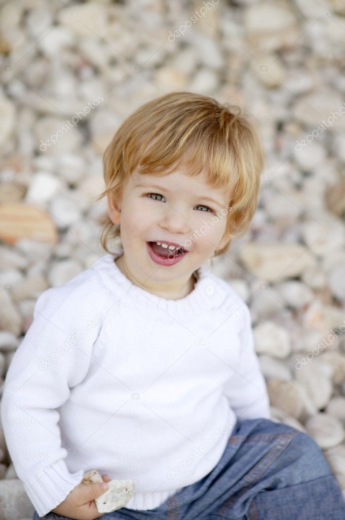Blond boy smiling on a rolling stones background